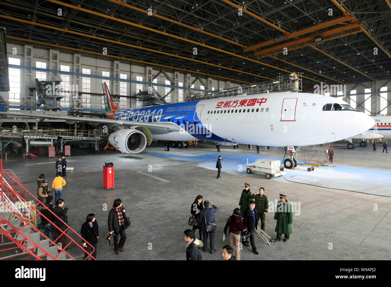 Visitors look at the fourth Airbus A330-300 jet plane which China Eastern Airlines delivered for the Expo 2010 in a hangar at the Hongqiao Internation Stock Photo