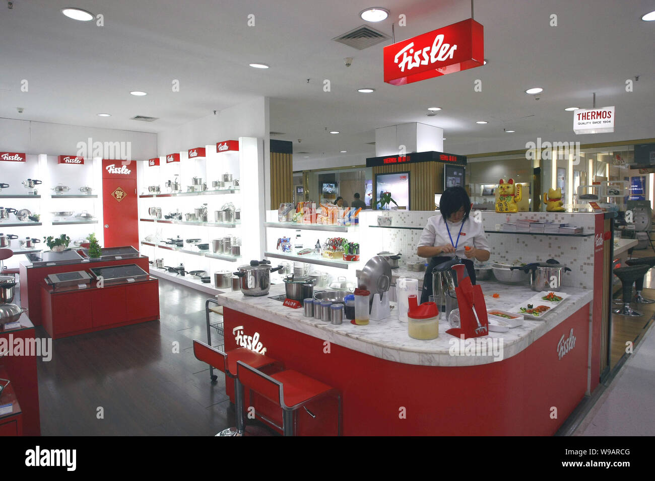 A Chinese staff is seen at the counter of Fissler at a department store in Shanghai, China, October 26, 2010. The International Business Times repor Stock Photo