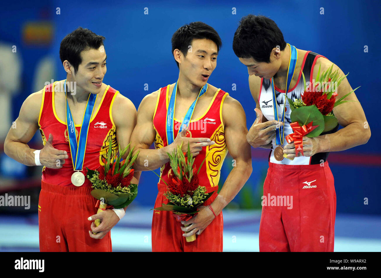 (From left) Chinas Lv Bo (silver medalist), Chinas Teng Haibin (gold medalist) and Hisashi Mizutori of Japan (bronze medalist) stand on the podium dur Stock Photo