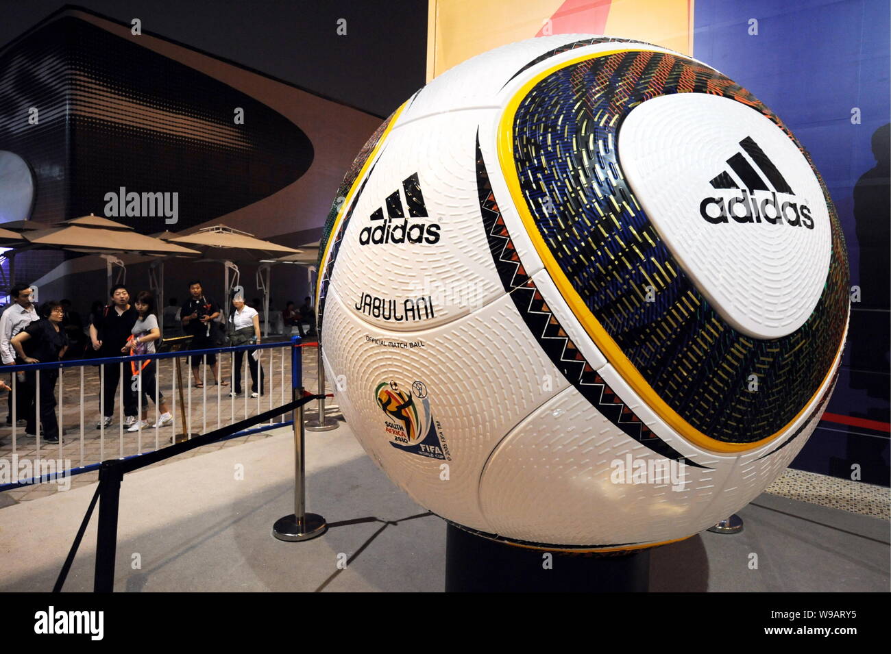 Visitors look at a big Adidas football for the 2010 FIFA World Cup inside the South Africa Pavilion in the World Expo Park in Shanghai, China, 19 May Stock Photo