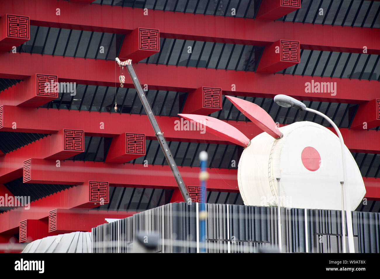 A crane is seen working in front of the China Pavilion in the World Expo Park in Shanghai, China, 2 November 2010.   Shanghai is now busy dismantling Stock Photo