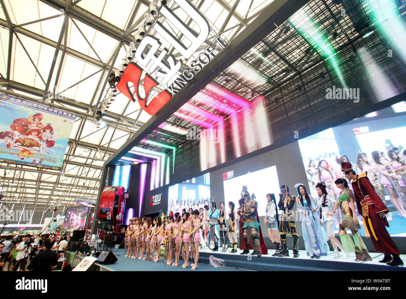 Chinese models wearing COSPLAY outfits pose at the stand of Kingsoft ...