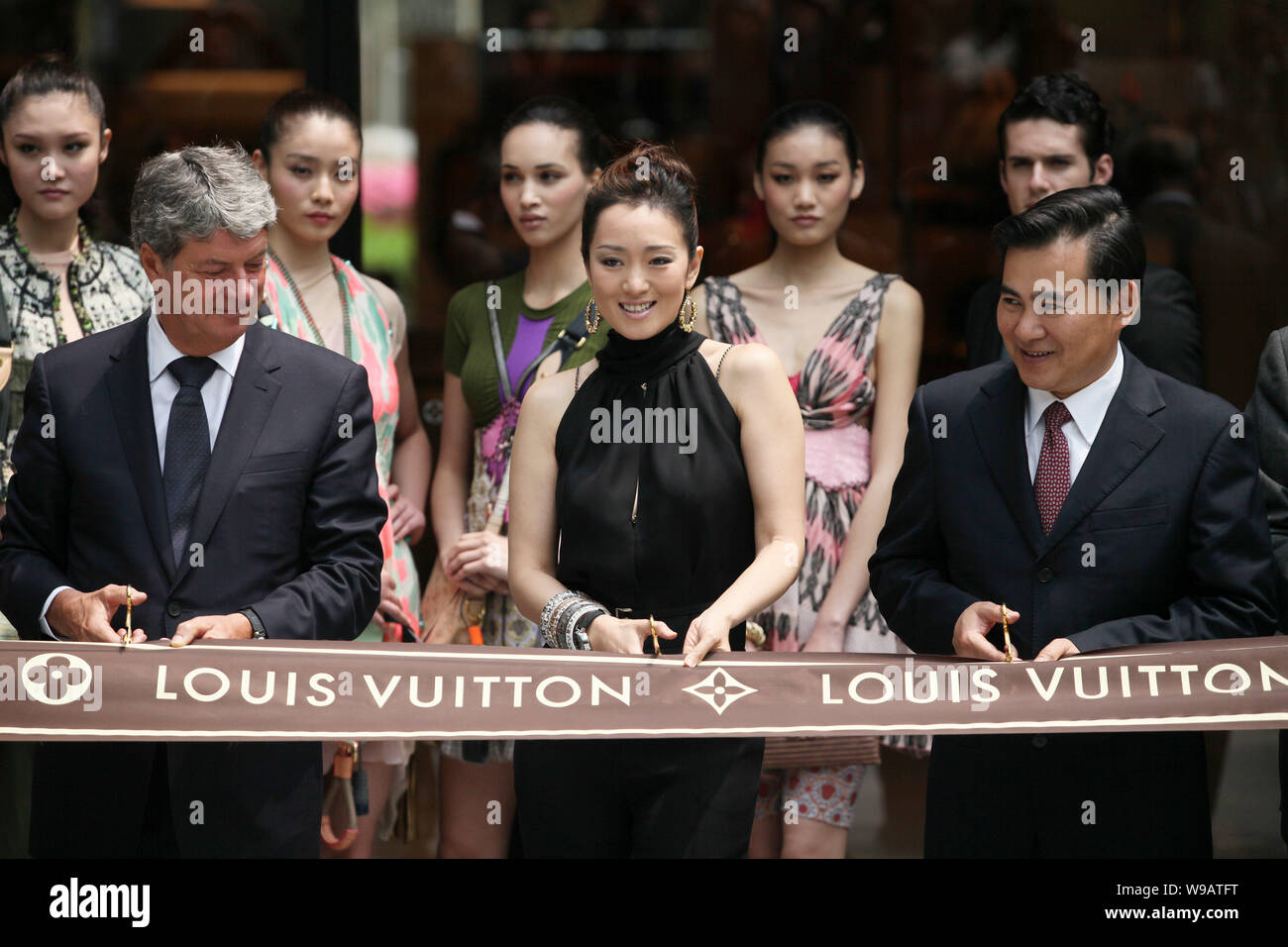 Yves Carcelle (L), Chairman and CEO of Louis Vuitton, Chinese actress Gong  Li (C) and an unnamed guest cut the ribbon during the opening ceremony of a  Stock Photo - Alamy