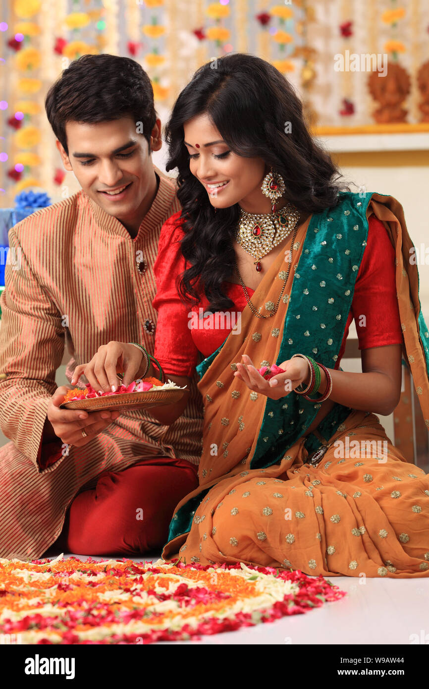 Indian couple making rangoli hi-res stock photography and images - Alamy