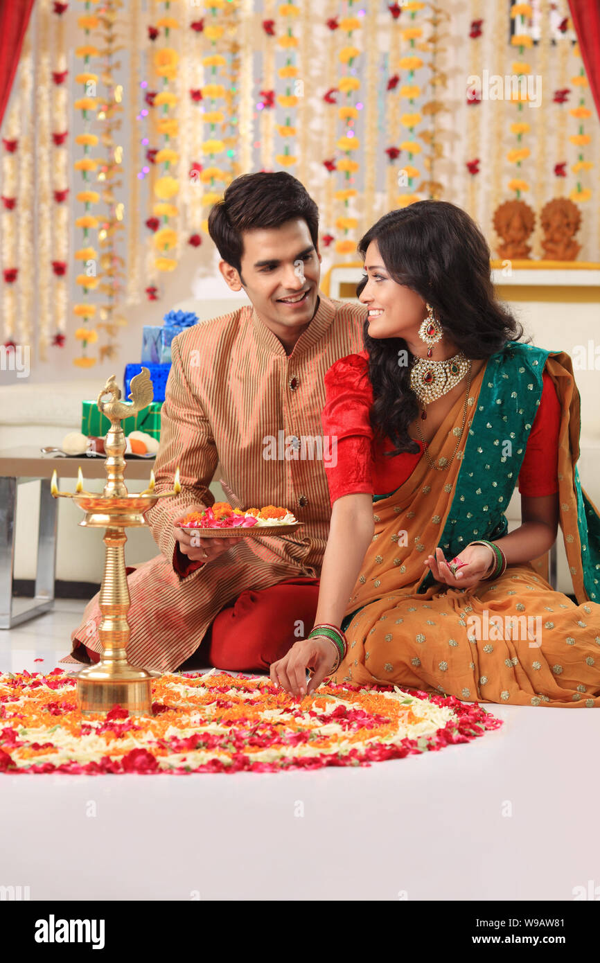 Young couple making rangoli Stock Photo - Alamy