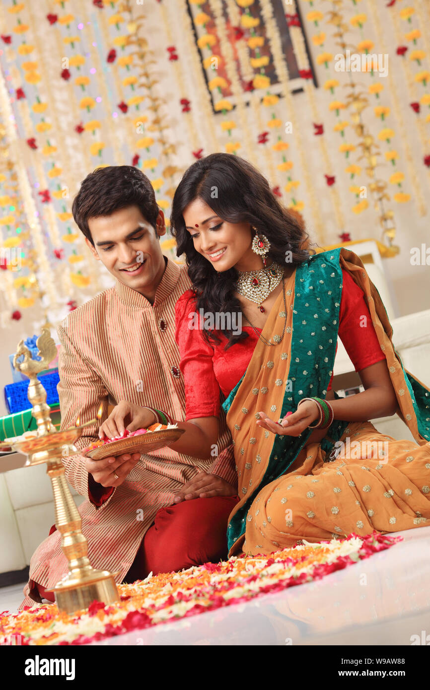 Young couple making rangoli Stock Photo