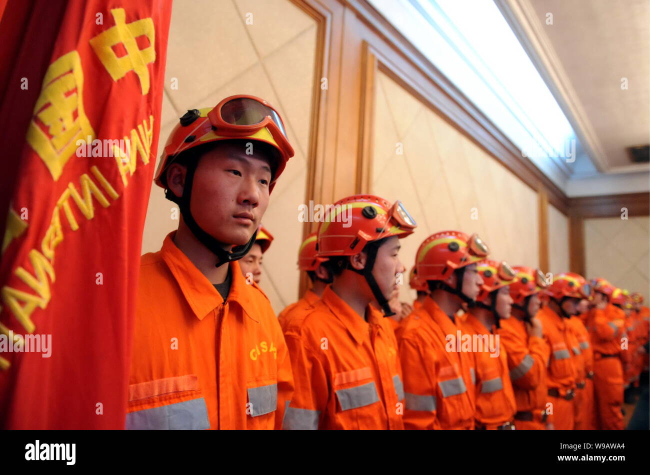 Chinese rescuers stand during a departure ceremony before leaving for ...