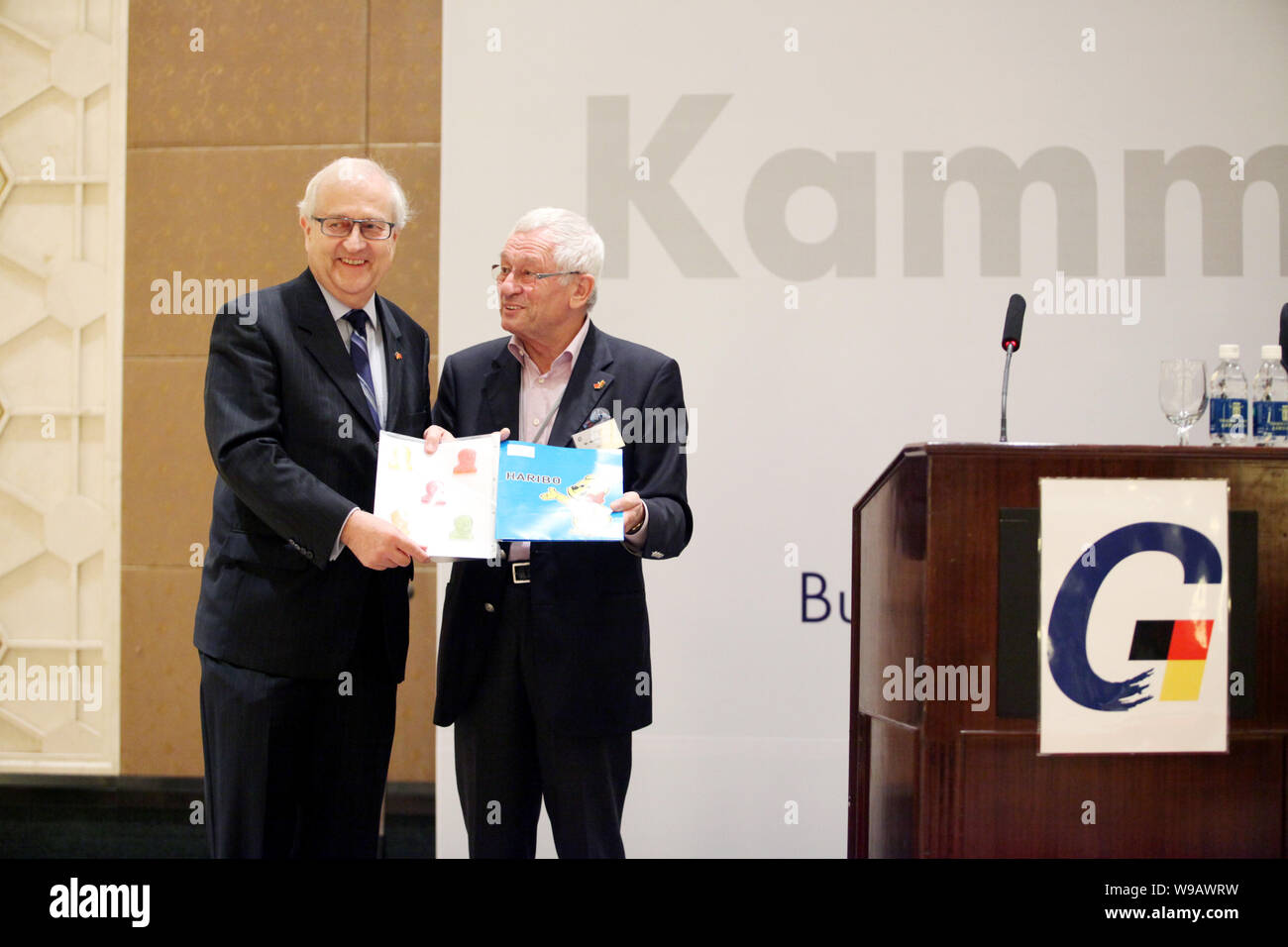 German Economy Minister Rainer Bruederle, left, is presented gifts by Mr. Manfred Knopp at a breakfast event of the German Chamber of Commerce in Shan Stock Photo