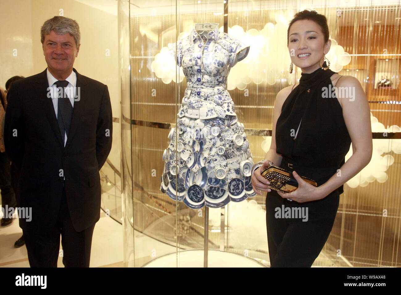 A Chinese woman wearing a Louis Vuitton dress and carrying a