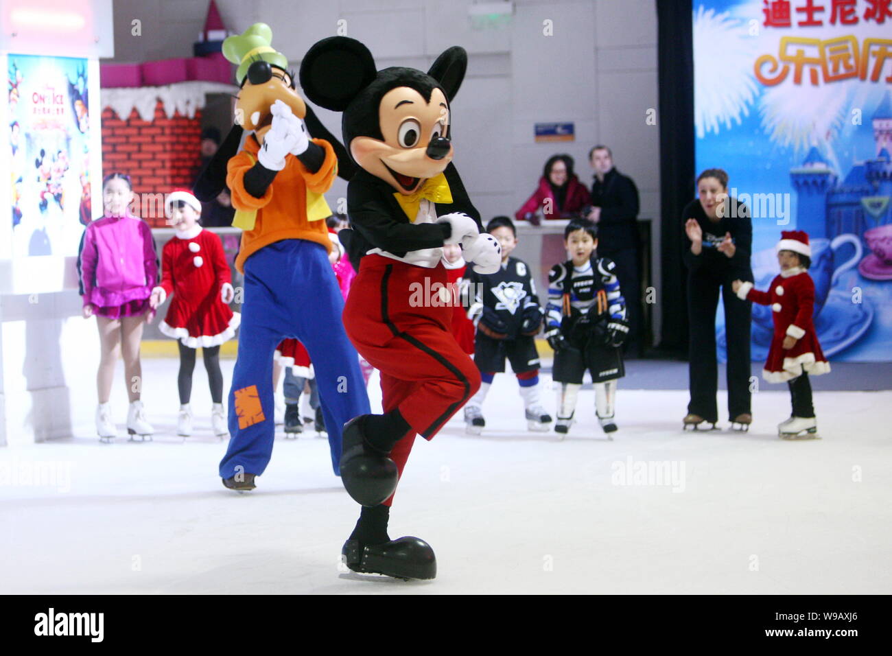 Mickey Mouse and Goofy skate in front of kids at a press