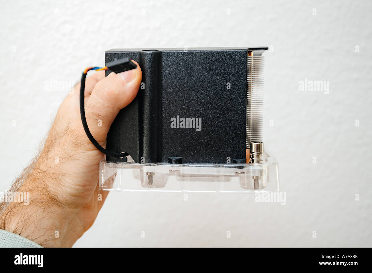Man hand holding against white background computer heatsink cpu cooler
