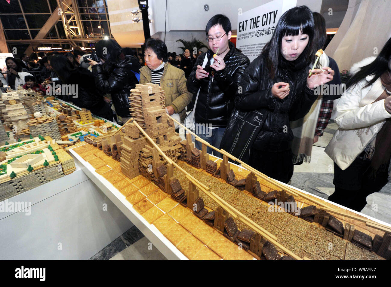 Visitors eat biscuits taken from a model of the London Bridge and other