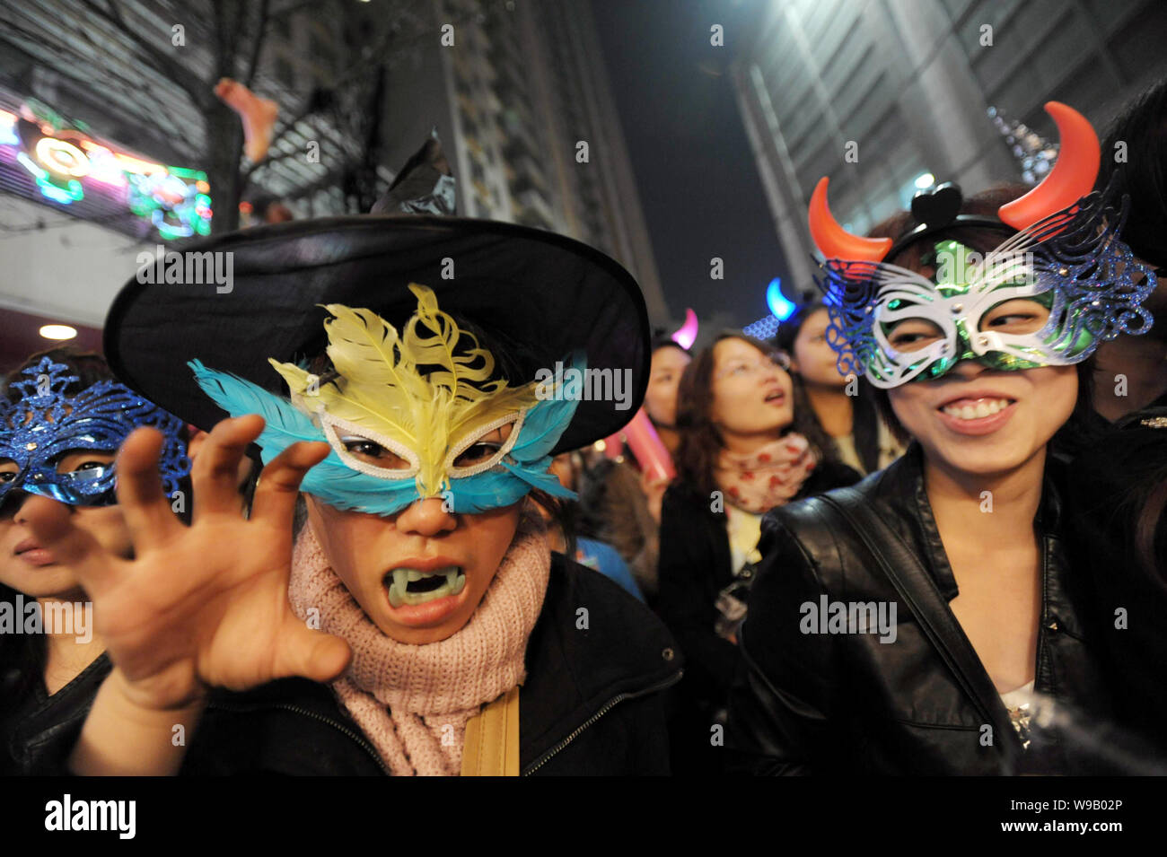 Young Chinese people dressed for Halloween gesture during a celebration in Wuhan city, central Chinas Hubei province, 30 October 2010. Stock Photo
