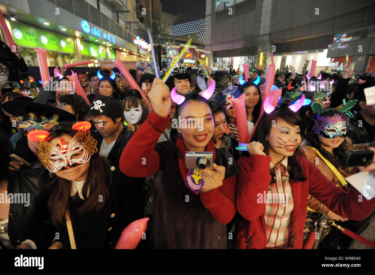 Young Chinese people dressed for Halloween celebrate on the street in Wuhan city, central Chinas Hubei province, 30 October 2010. Stock Photo