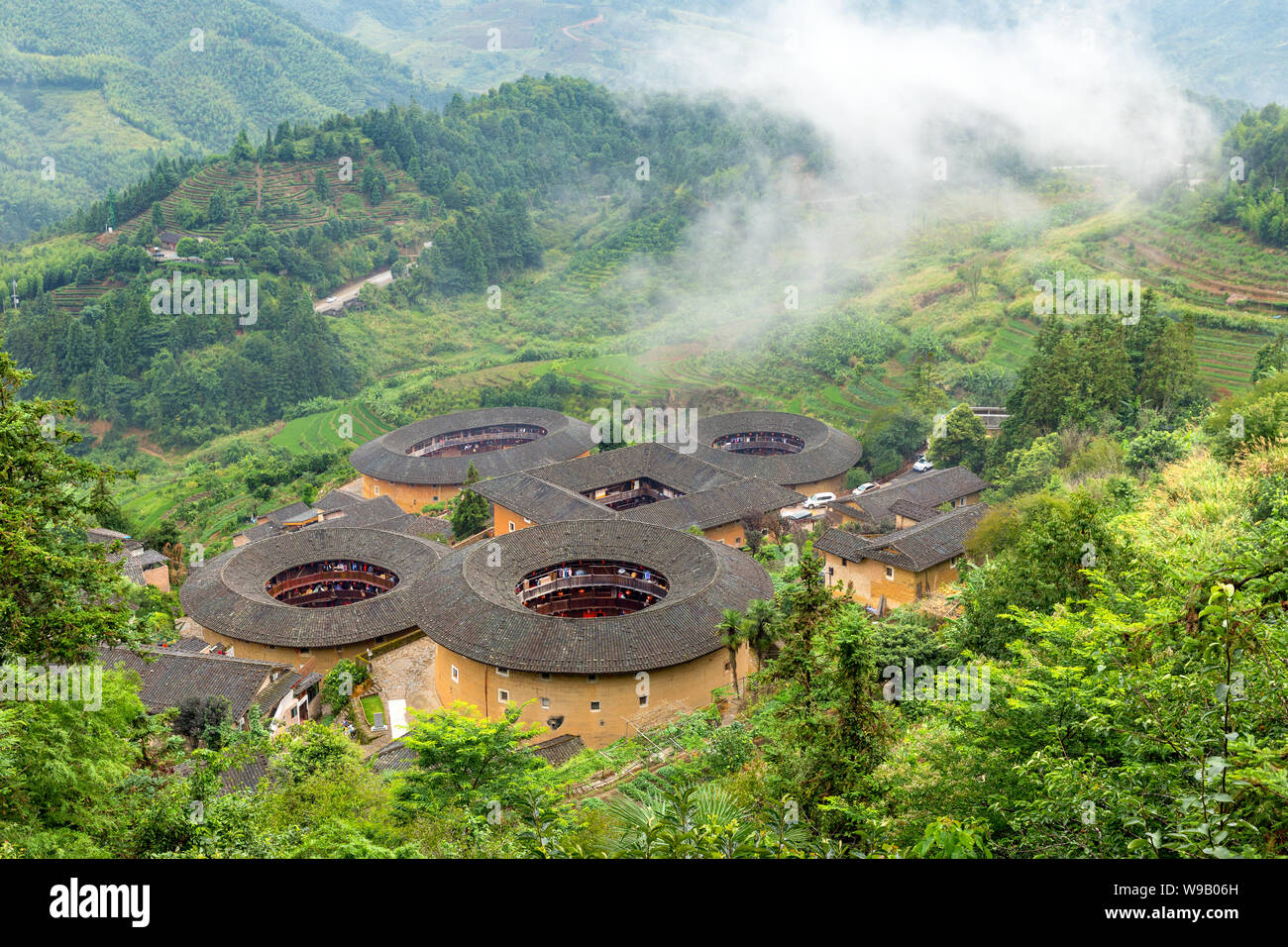 aerial view of Tianluokeng Tulou cluster with mist Stock Photo
