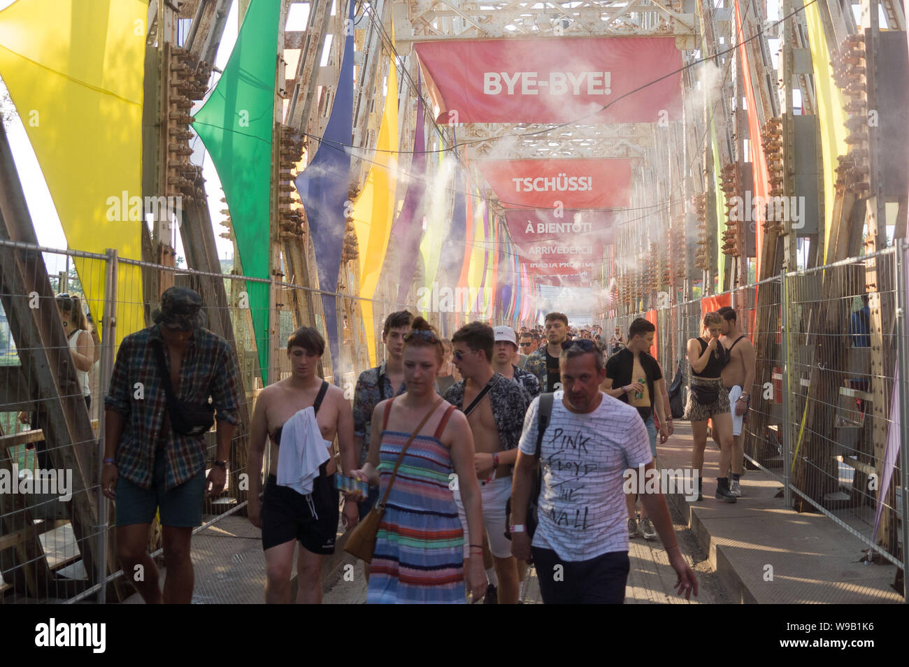 Budapest, Hungary. 12th Aug, 2019. People walk under cooling fog from water spray installations during the Sziget Festival in Budapest, Hungary, Aug. 12, 2019. Credit: Attila Volgyi/Xinhua Stock Photo