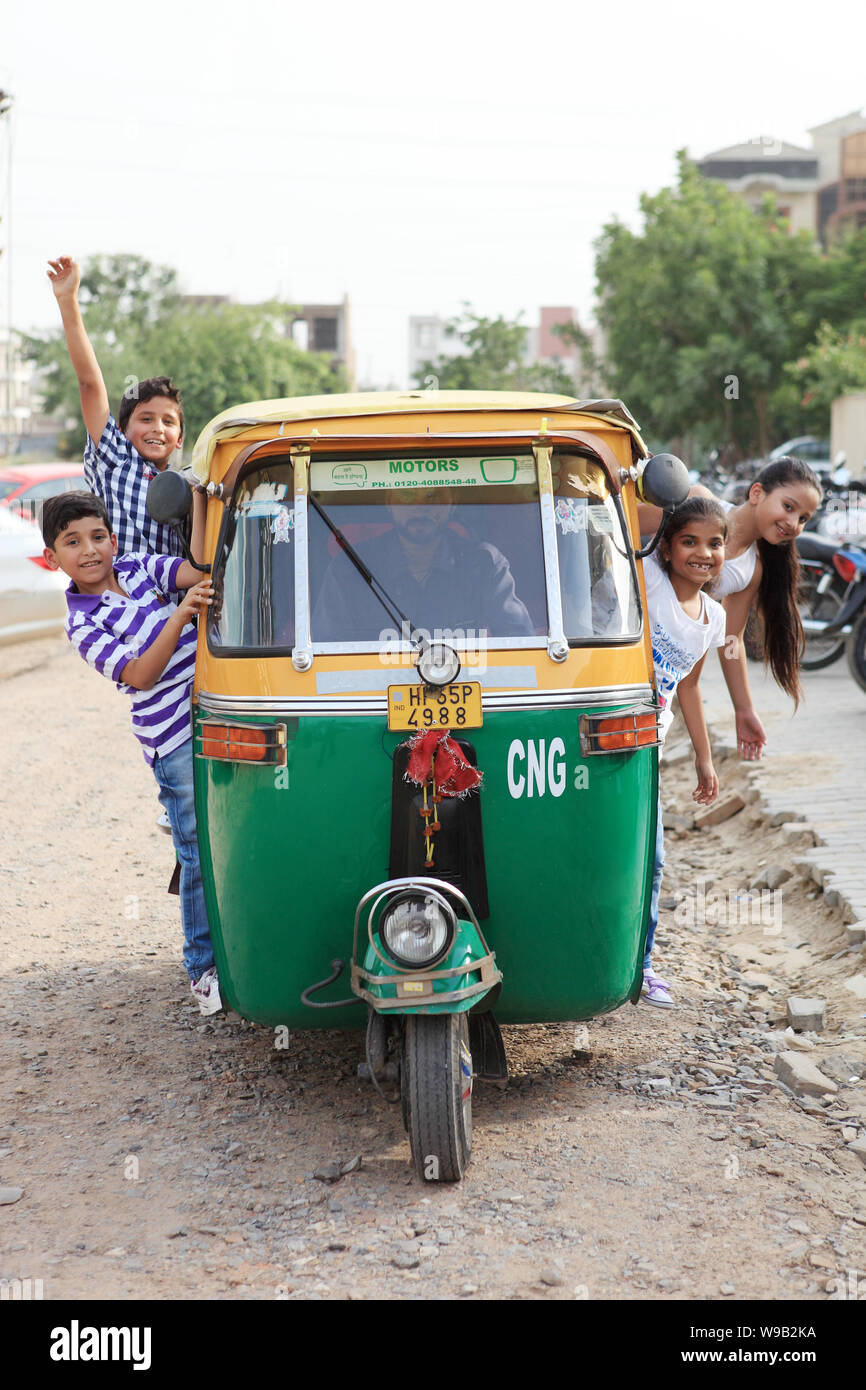Group of children playing in an auto rickshaw Stock Photo