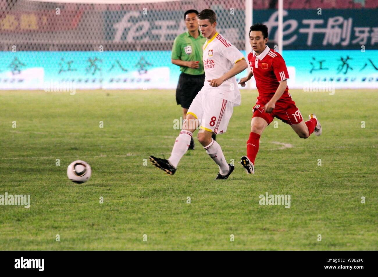 Yang Hao, right, of the Chinese national mens soccer team follows Lars Bender of Bayer 04 Leverkusen Football Club during a friendly soccer match in J Stock Photo