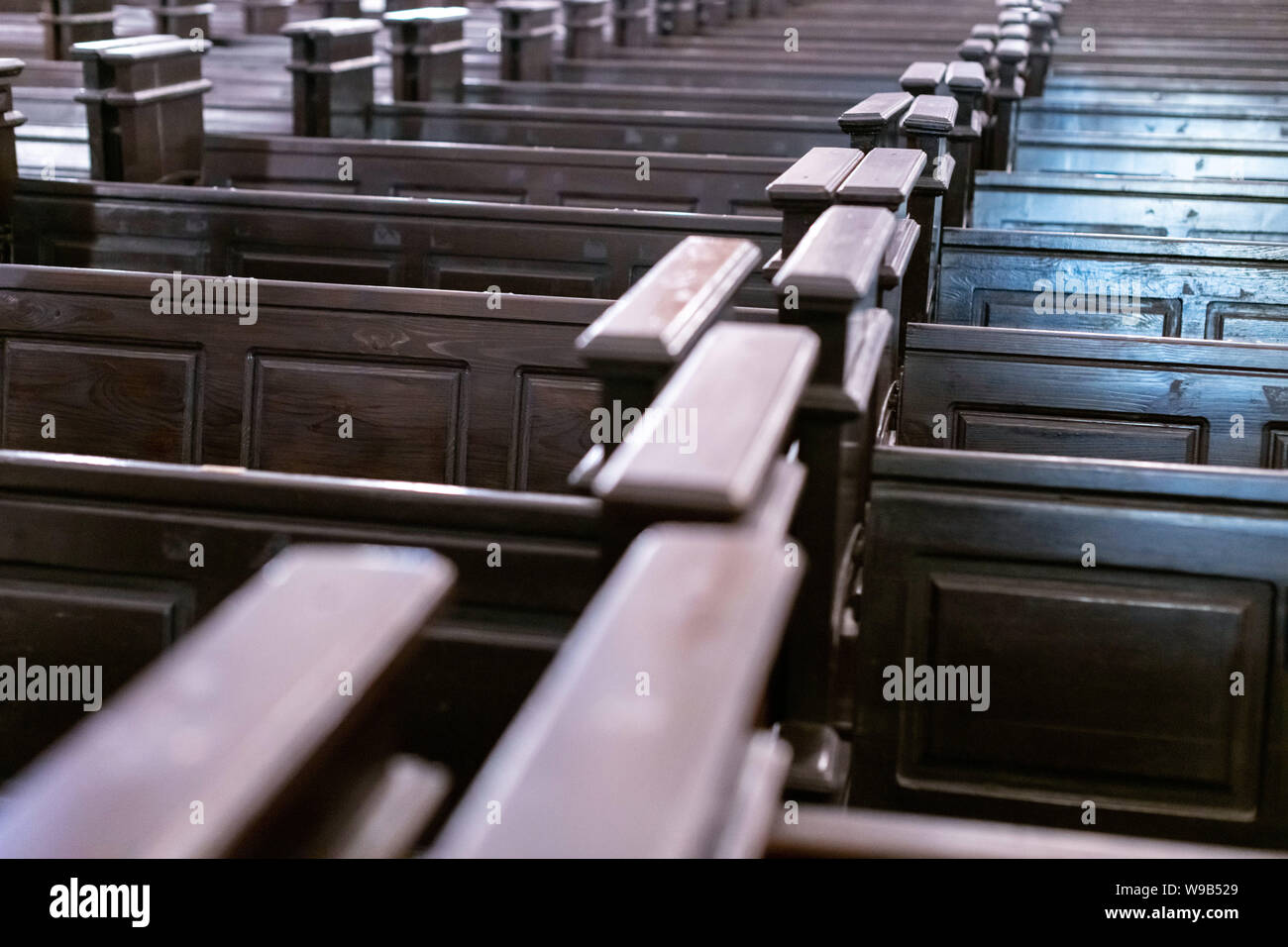 Cathedral benches. Rows of pews in christian church. Heavy solid