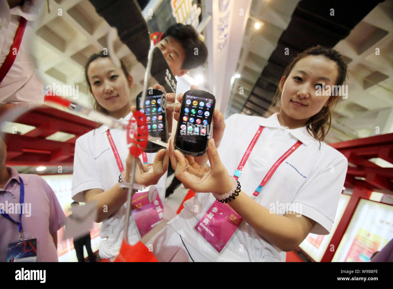 --FILE--A Chinese staff shows a Lenovo LePhone mobile phone during a fair in Beijing, China, 27 May 2010.   Lenovo Group Ltd. hopes to further tap int Stock Photo