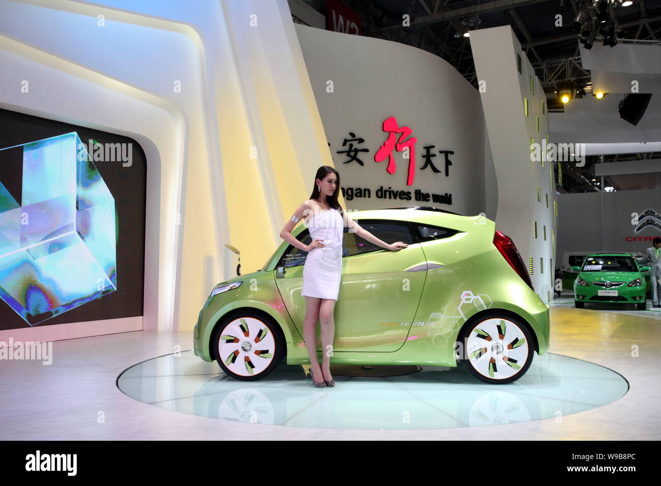 A model poses next to the Chana (ChangAn) Green-i concept EV at the ...