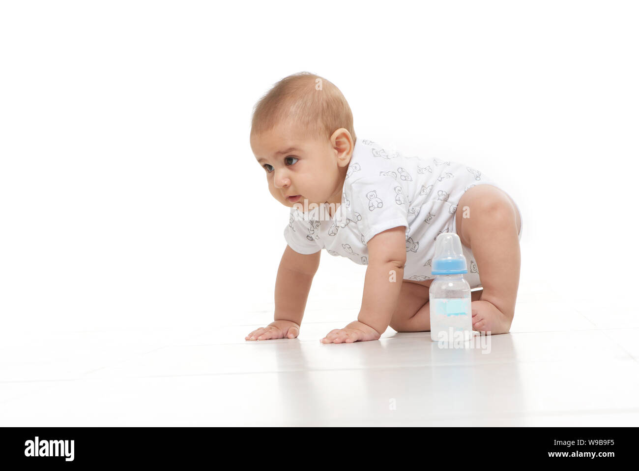 Baby boy crawling on floor Stock Photo