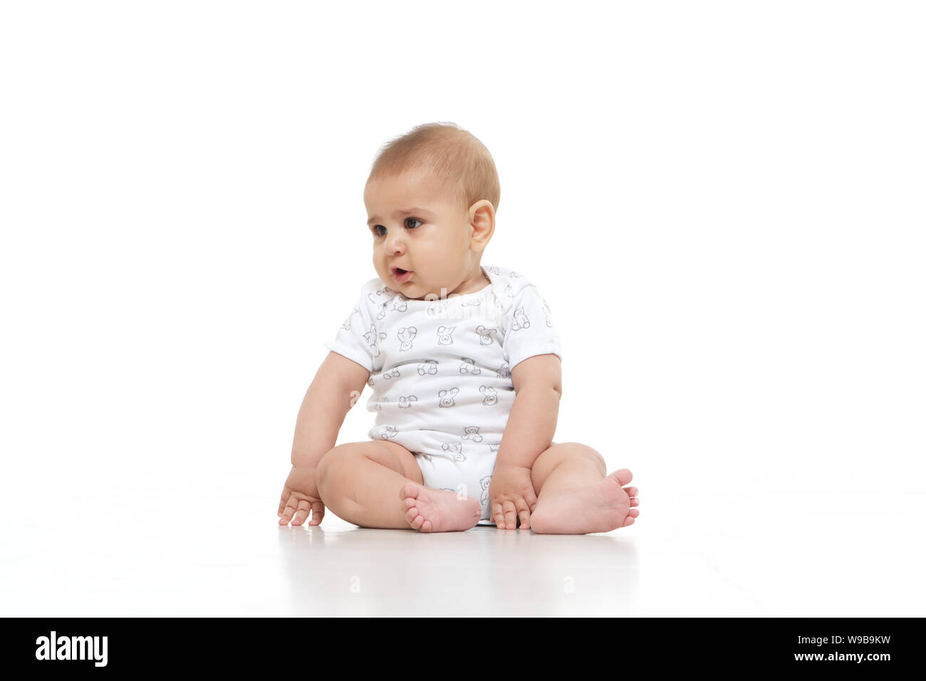 Baby boy sitting on floor Stock Photo - Alamy