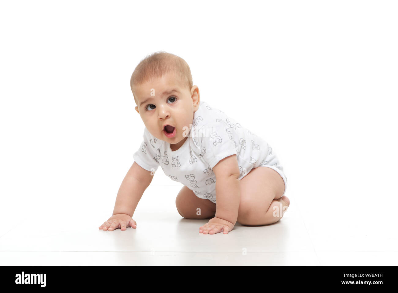 Baby boy crawling on floor Stock Photo