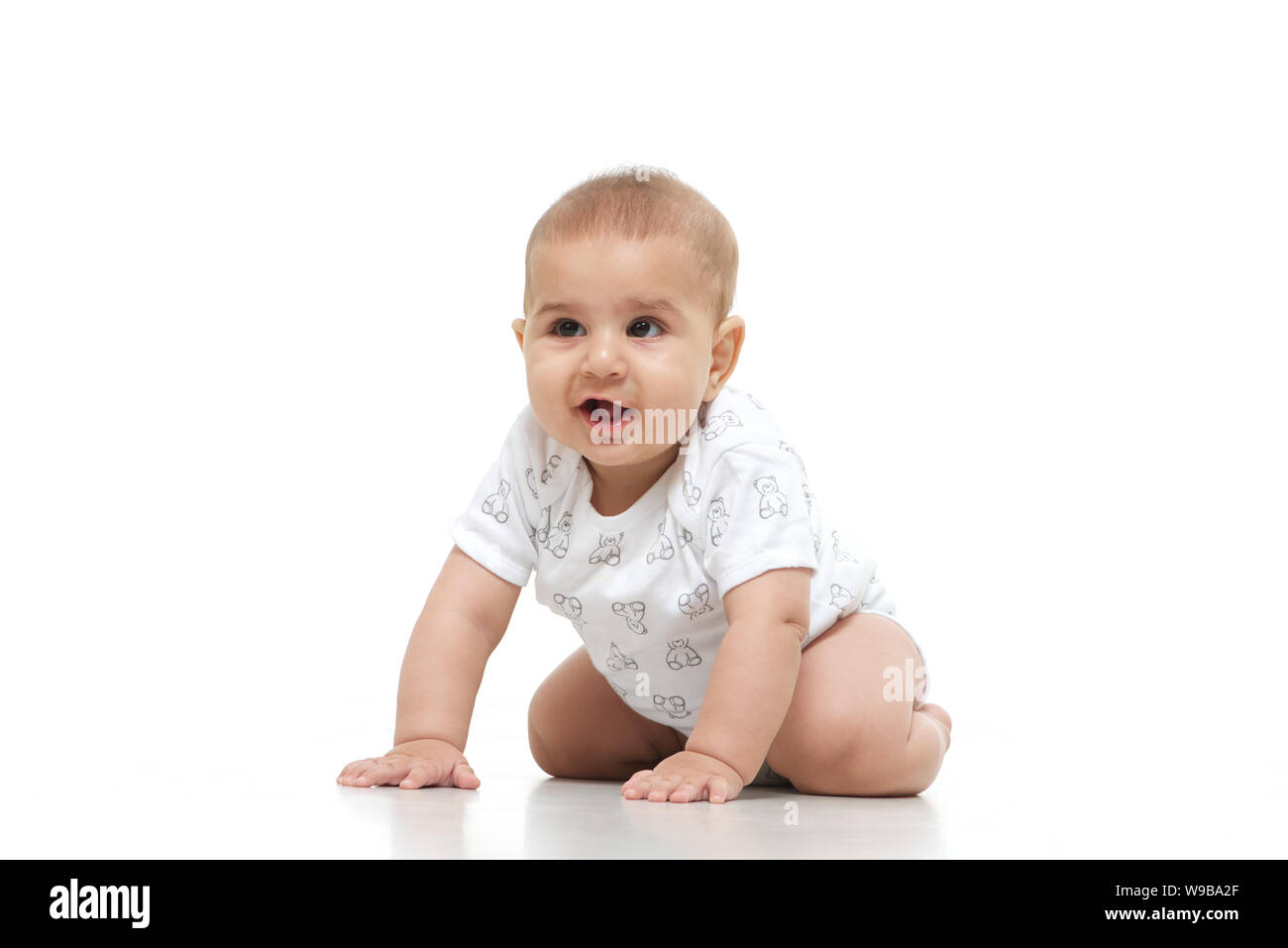 Baby boy crawling on floor Stock Photo