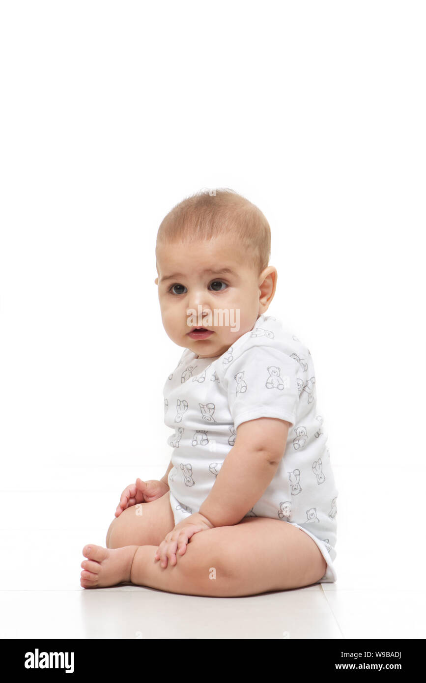 Baby boy sitting on floor Stock Photo - Alamy
