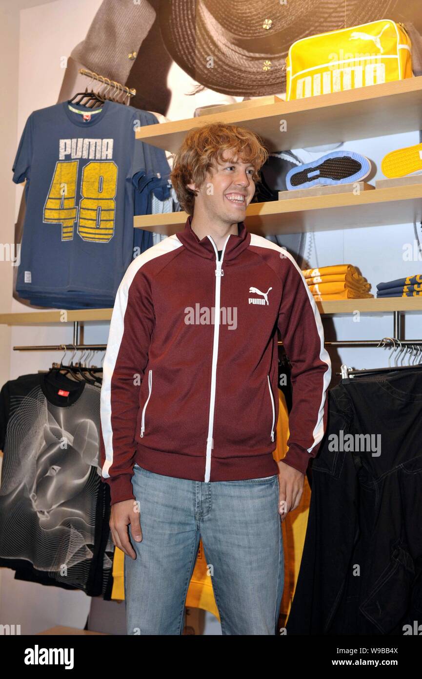 German F1 driver Sebastian Vettel of Red Bull tries a coat at a Puma store  in Shanghai, China, April 15, 2010. The Formula One Chinese Grand Prix 20  Stock Photo - Alamy