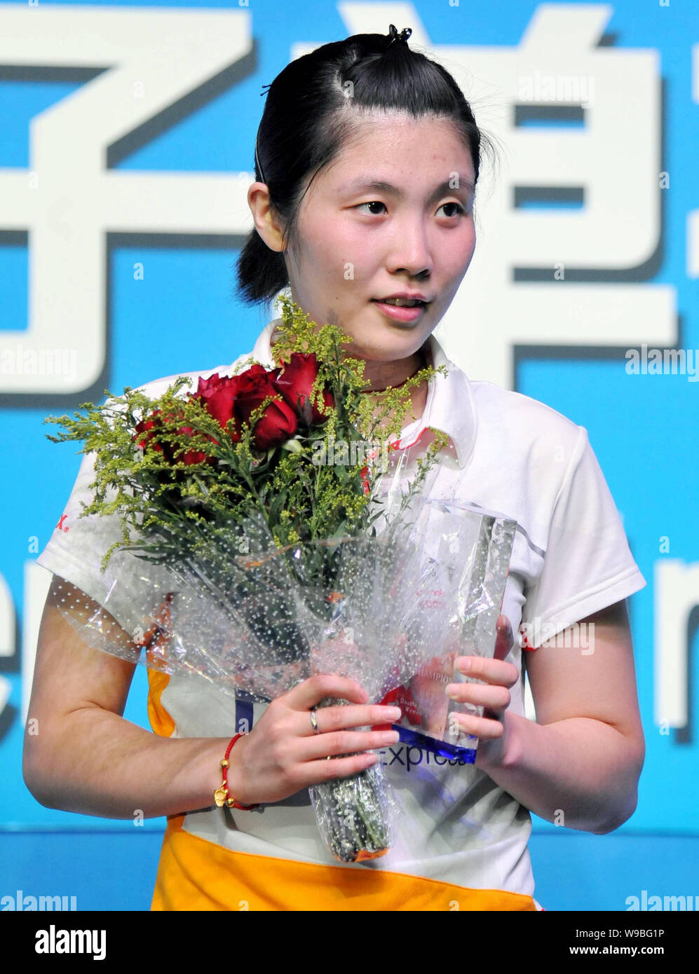 Chinas Jiang Yanjiao poses with the champion trophy during an award ceremony after the final of the womens singles at the China Open Badminton Champio Stock Photo