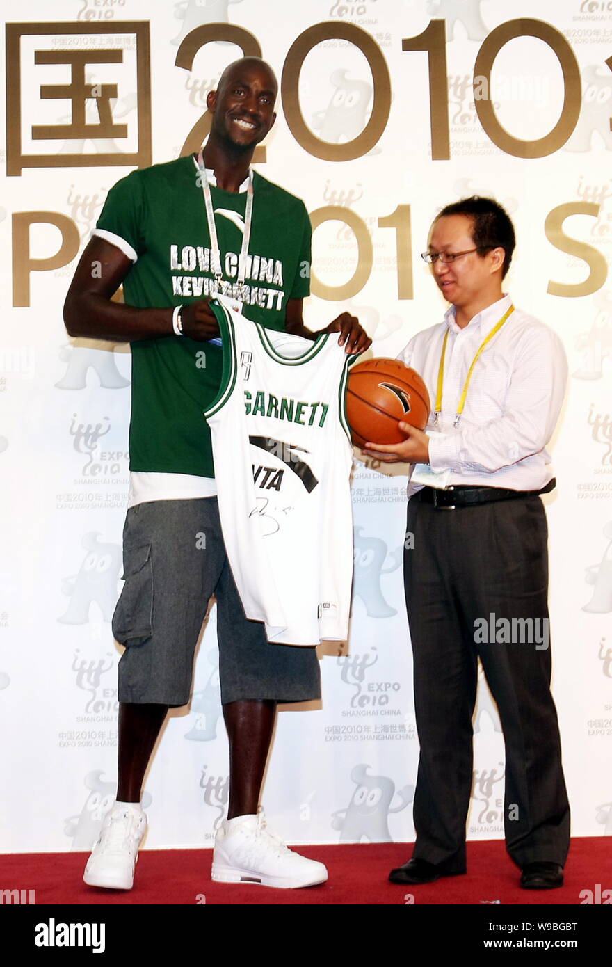 NBA basektball player Kevin Garnett of the Boston Celtics (left) shows a jersey and a basketball with his signature at a meeting with Chinese basketba Stock Photo