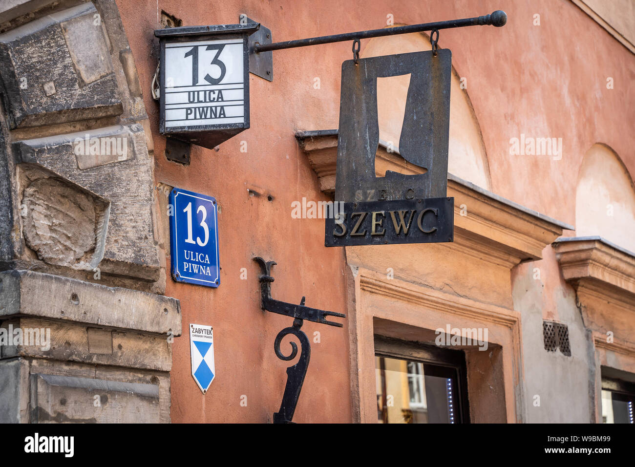Warsaw, Poland - August 2019: Metal sign of a Boot repair shop in Warsaw Old Town (Ulica Piwna Street) Stock Photo