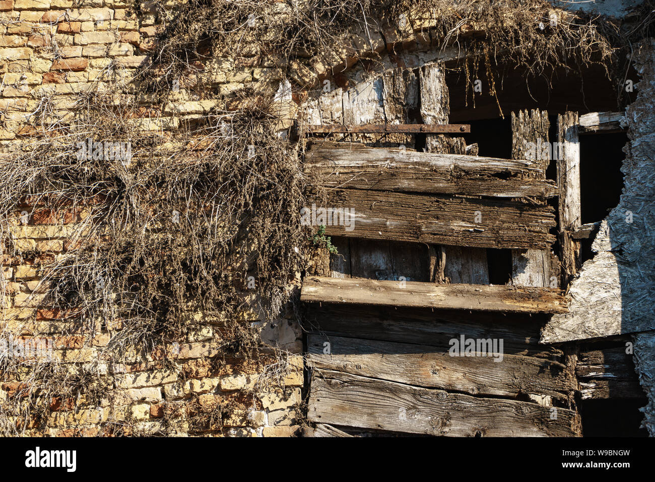 Old window of a brick building clogged with boards Stock Photo - Alamy