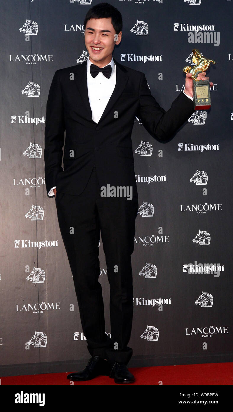 Taiwanese actor Ethan Ruan holds the trophy of the Best Actor at the ...