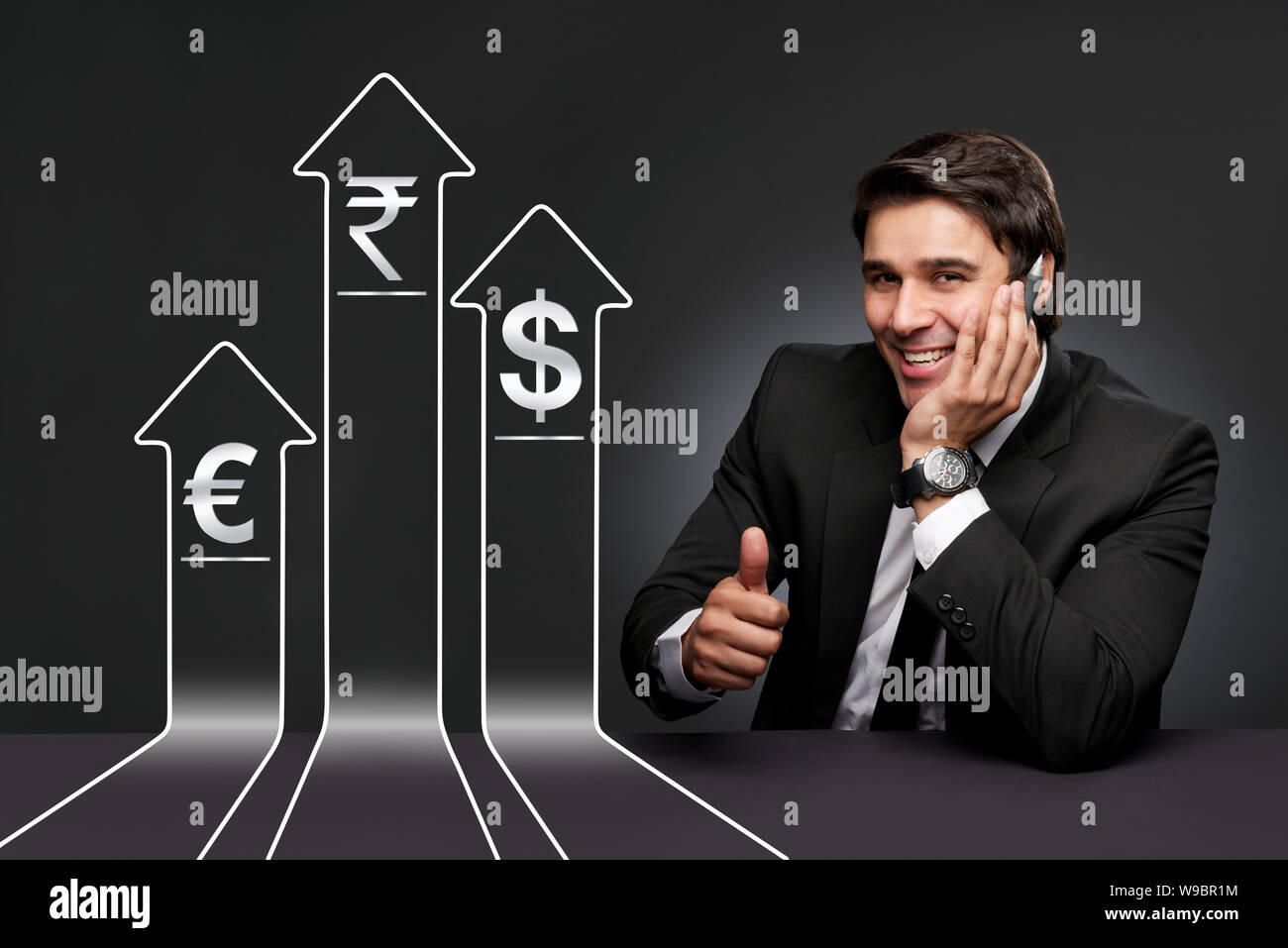 Businessman showing thumbs up near exchange rate graph Stock Photo - Alamy