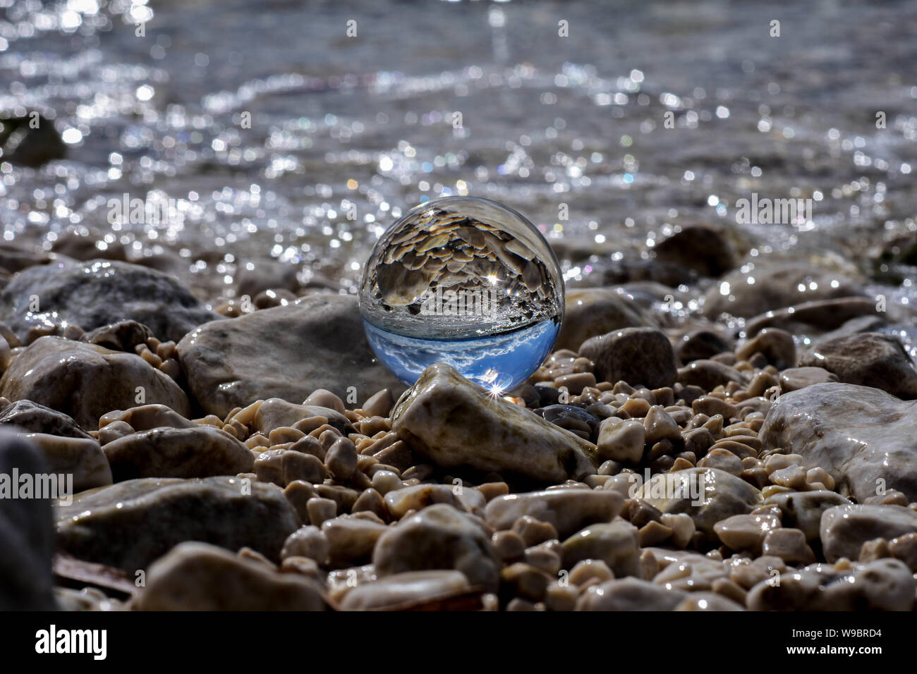 Concept  of summer/ Crystal ball whit sea reflection at the beach Stock Photo