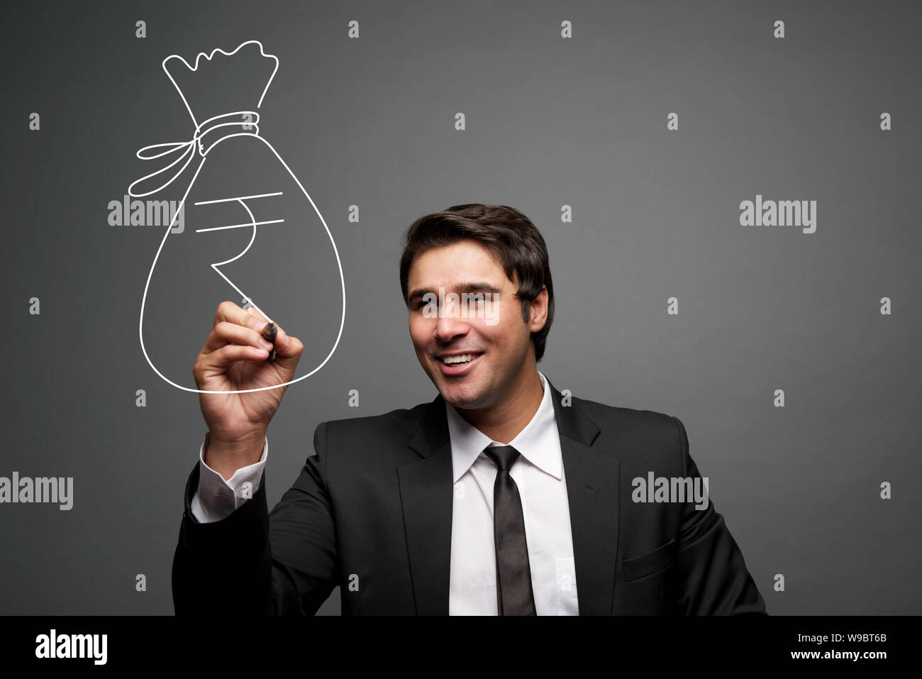 Businessman making a rupee symbol Stock Photo