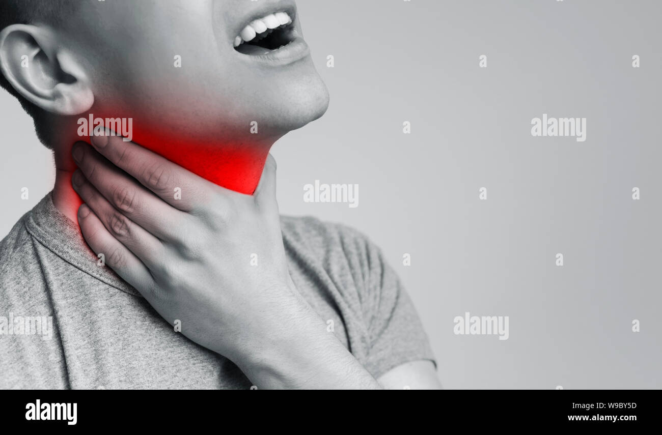 Young unhealthy guy coughing, has sore throat Stock Photo Alamy