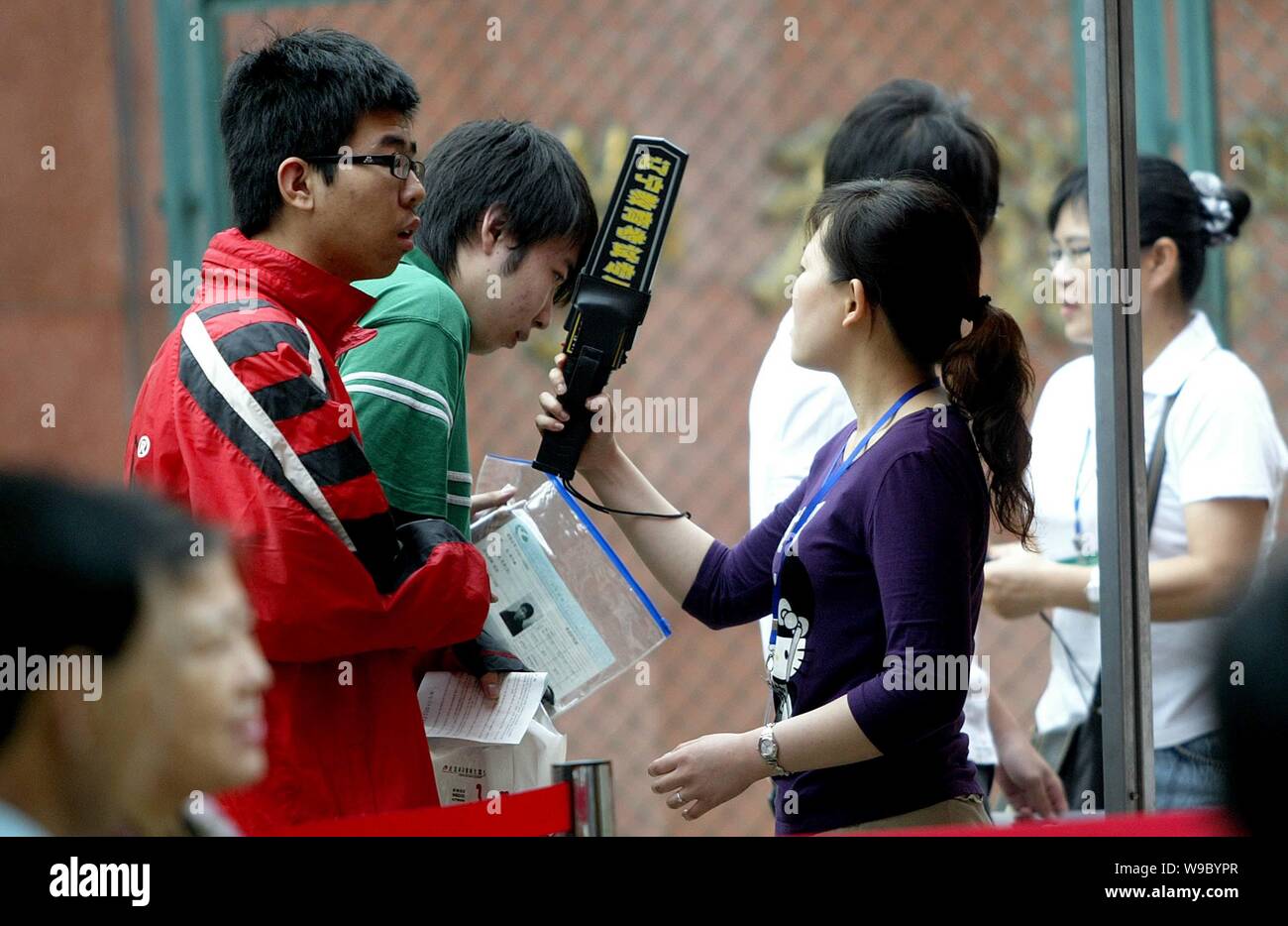 Chinese students go through checks for cheating devices before attending the national college entrance examination in Shenyang, northeast Chinas Liaon Stock Photo