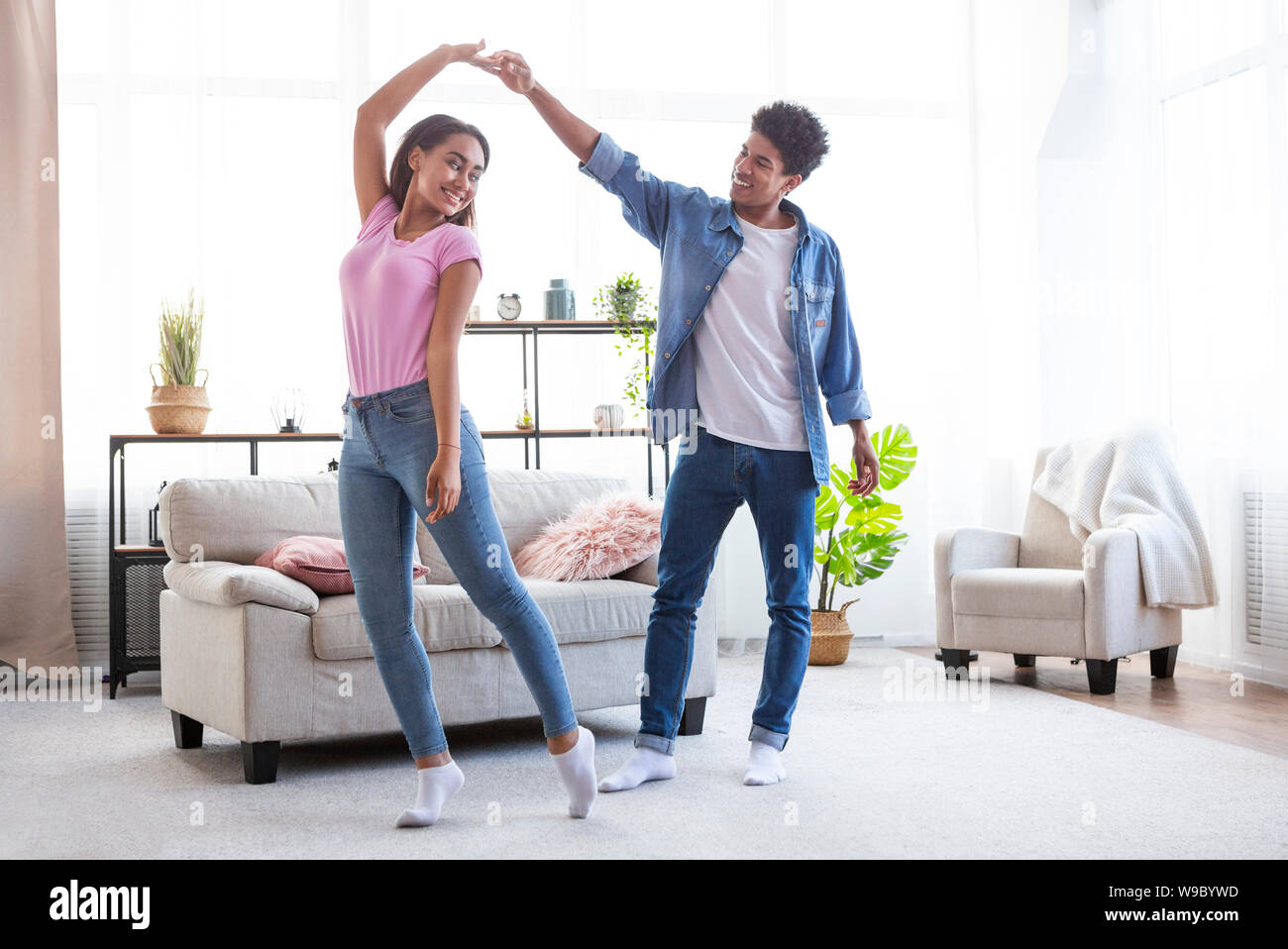 Romantic teen african american couple dancing at home Stock Photo
