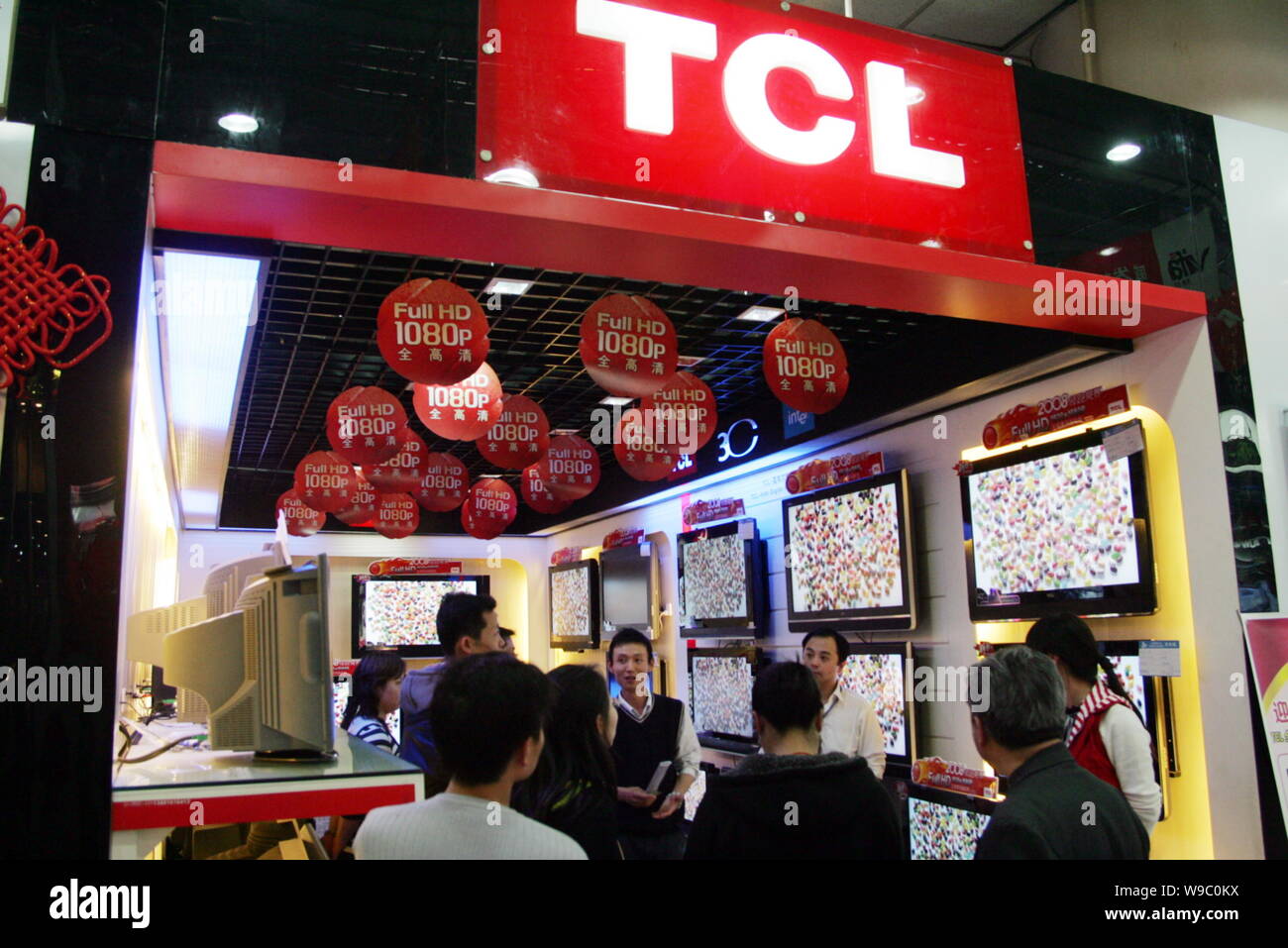 --FILE--Chinese customers look at TCL LCD televisions at a store in Shanghai, China, 6 April 2008.   TCL Corp. plans to raise as much as 5 billion yua Stock Photo
