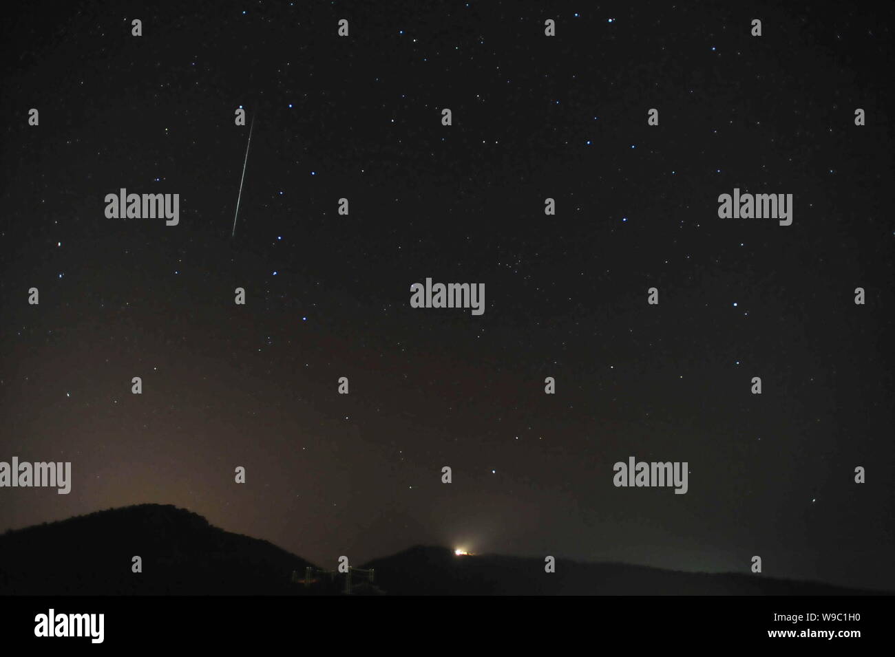 The Geminid meteor shower is seen in the night sky over Qingdao city, east Chinas Shandong province, Monday, 14 December 2009.   In a year full of met Stock Photo
