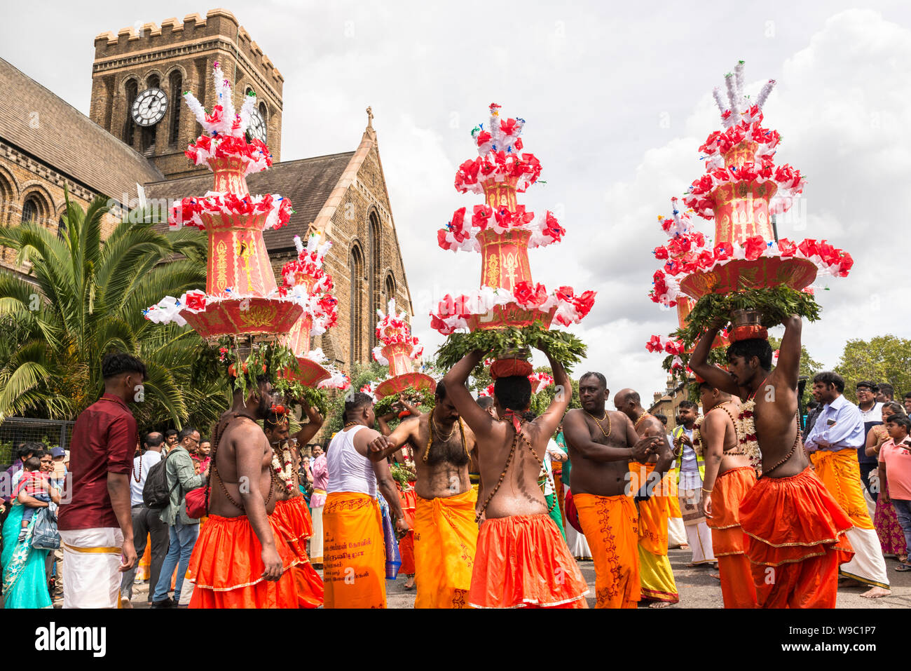 Bare chested men dancing during the Tamil Chariot Festival, an annual Hindu festivity, which