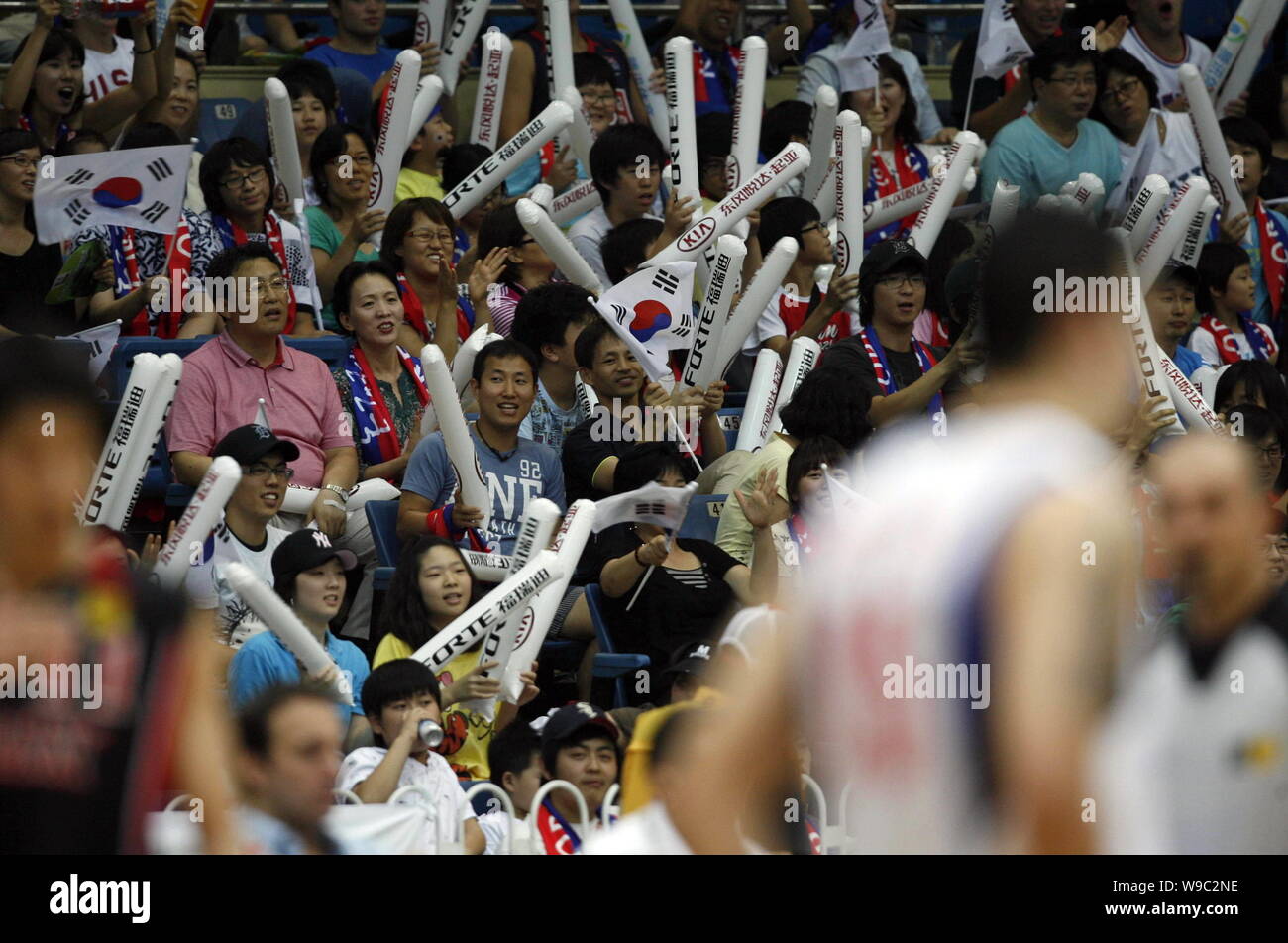 South Korean fans waves flags and hit inflatable sticks to show support