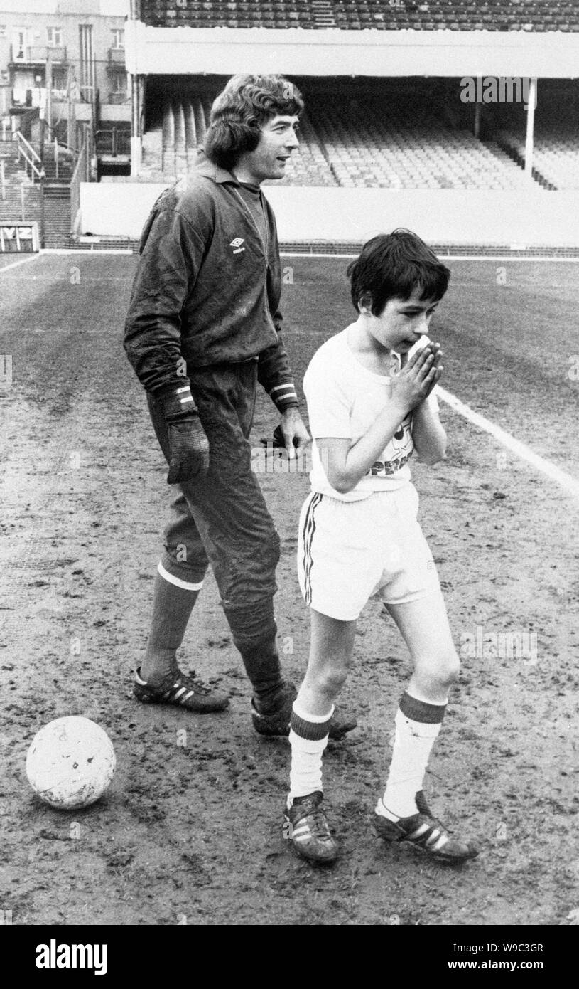 Kevin Gilzean, 11, offers up a prayer after beating Arsenal goalkeeper Pat Jennings three times from the penalty spot at Highbury. Kevin is the son of former Scotland star Alan Gilzean, who was also a Spurs teammate of Pat Jennings. Kevin, of Raglan Junior School, Enfield, was one of 12 competing in the Superdrive penalty tournament by Shell UK. Stock Photo