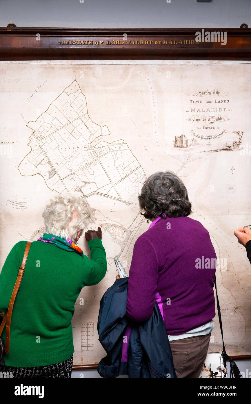 Ireland, Leinster, Fingal, Co Dublin, Malahide Castle, interior, visitors inspecting Demesne map Stock Photo