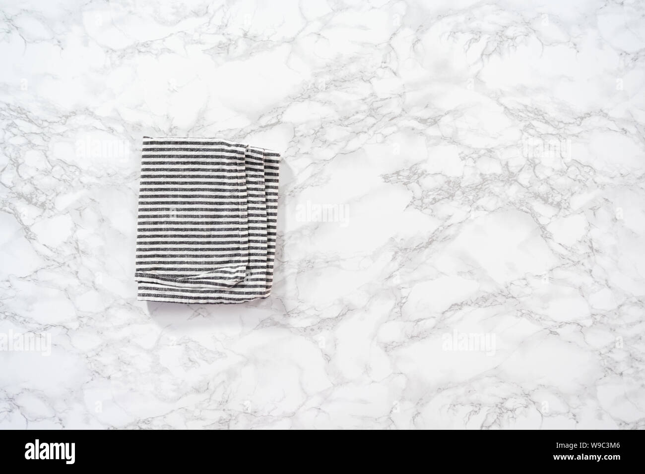 Flat lay. Kitchen towels with white and black stripes on the marble counter Stock Photo Alamy