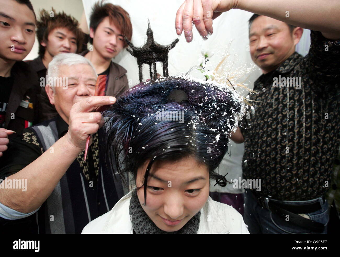 Chinese hairdressers create a pavilion-shaped hairstyle resembling the Melting Snow at Broken Bridge, one of the Ten Views of the West Lake, on the he Stock Photo